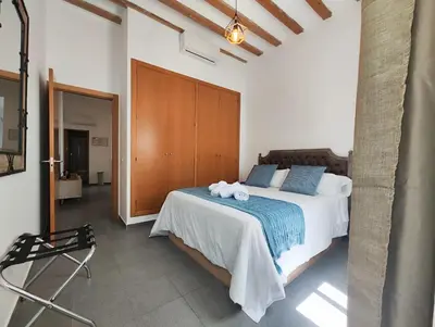 a bedroom with a bed with towels on it at Suite del Mercado Little Apartments in Cádiz