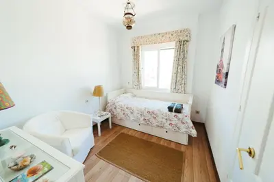 a small bedroom with a bed and a window at Andalusian beach haven villa in El Puerto de Santa María