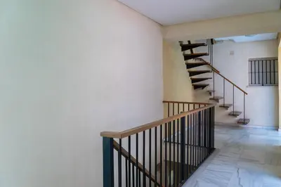 a winding staircase in a room with white walls at Casa Palacio la Mar Salá in El Puerto de Santa María