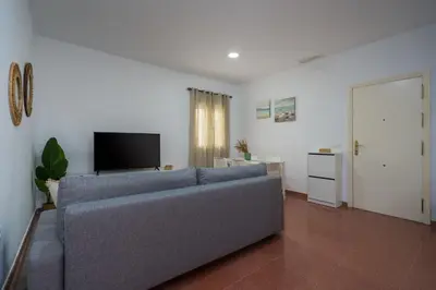 a living room with a couch and a television at Casa Palacio la Mar Salá in El Puerto de Santa María