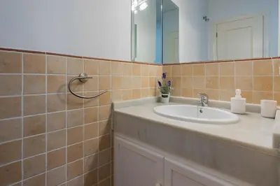 a bathroom with a sink and a mirror at Casa Palacio la Mar Salá in El Puerto de Santa María