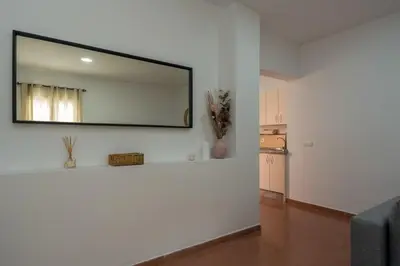 a living room with a mirror on the wall at Casa Palacio la Mar Salá in El Puerto de Santa María