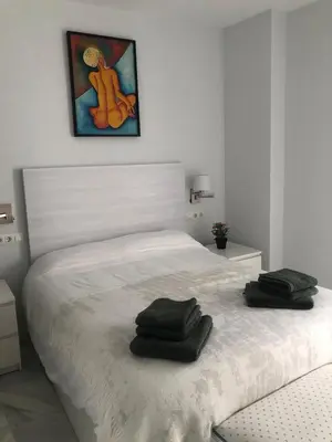 a bedroom with a bed with two towels on it at Centro de Sanlúcar in Sanlúcar de Barrameda