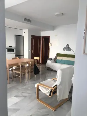 a living room with a bed and a dining room at Centro de Sanlúcar in Sanlúcar de Barrameda