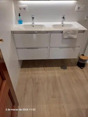 a bathroom with a white sink and a wooden floor at Centro de Sanlúcar in Sanlúcar de Barrameda