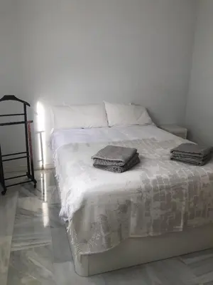 a bed with two towels on it in a room at Centro de Sanlúcar in Sanlúcar de Barrameda