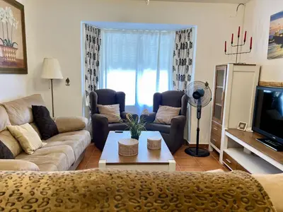 a living room with a couch and a tv at Casa Manolete in Chiclana de la Frontera