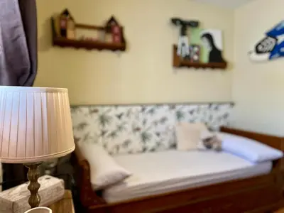 a bed in a room with a lamp and shelves at Casa Manolete in Chiclana de la Frontera