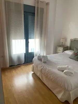a bedroom with a bed with towels on it at ARCO PLAZA DE ESPAÑA CADIZ in Cádiz