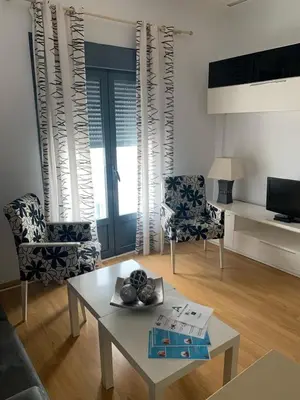 a living room with a table and two chairs at ARCO PLAZA DE ESPAÑA CADIZ in Cádiz