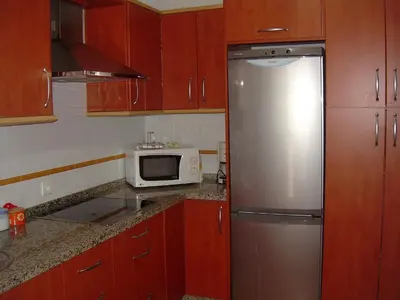 a kitchen with a stainless steel refrigerator and a microwave at Apartamento céntrico JARDINES DE LA INFANTA, con garaje privado in Sanlúcar de Barrameda