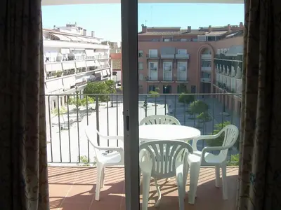 a table and chairs on a balcony with a view at Apartamento céntrico JARDINES DE LA INFANTA, con garaje privado in Sanlúcar de Barrameda