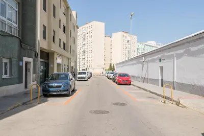 a street with cars parked on the side of the road at Playamar in Cádiz