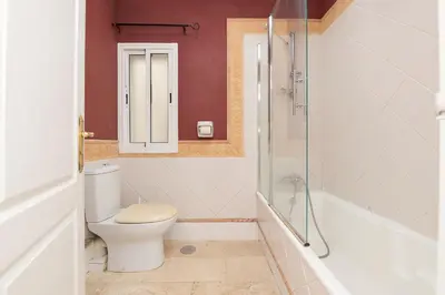 a bathroom with a toilet and a glass shower at Playamar in Cádiz