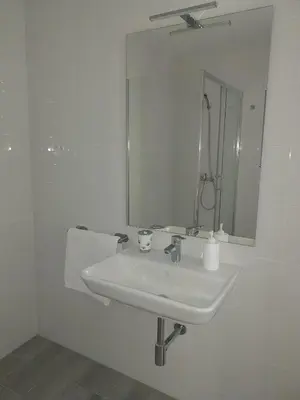 a white bathroom with a sink and a mirror at Brisas de Puerto Real in Puerto Real
