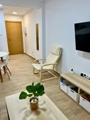 a living room with a chair and a table at Adana Beach House in Cádiz