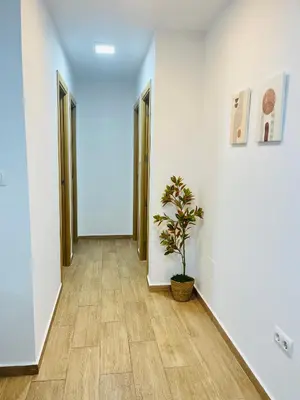 a hallway with two doors and a potted plant at Adana Beach House in Cádiz