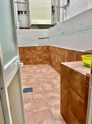 a bathroom with a tiled floor and a counter at Adana Beach House in Cádiz