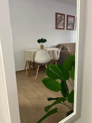 a dining room with a table and a chair at Adana Beach House in Cádiz