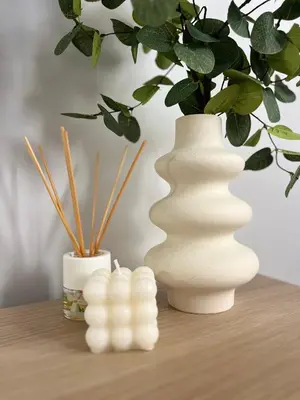 a white vase sitting on a table with a plant at Adana Beach House in Cádiz