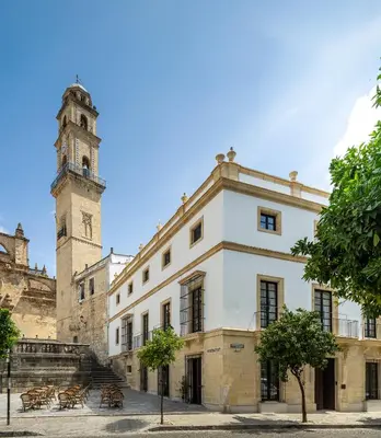 a building with a clock tower and a building at Hotel Boutique Sidonia in Jerez de la Frontera