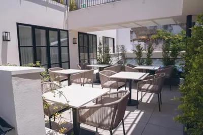 an outdoor patio with tables and chairs and plants at Hotel Boutique Sidonia in Jerez de la Frontera