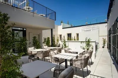 an outdoor patio with tables and chairs on a building at Hotel Boutique Sidonia in Jerez de la Frontera