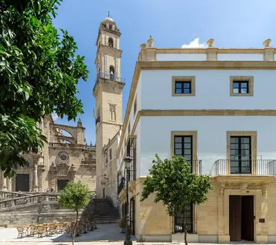 a building with a clock tower in the background at Hotel Boutique Sidonia in Jerez de la Frontera