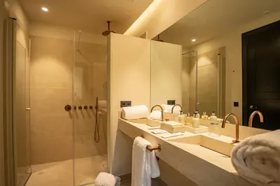 a bathroom with a shower and a sink and a mirror at Hotel Boutique Sidonia in Jerez de la Frontera