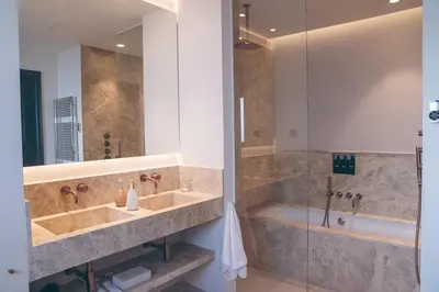a bathroom with two sinks and a shower and a tub at Hotel Boutique Sidonia in Jerez de la Frontera