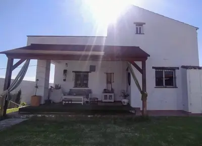 a white house with a gazebo in front of it at villa rana verde in Chiclana de la Frontera