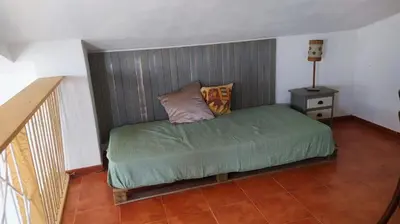 a bedroom with a bed with a headboard at villa rana verde in Chiclana de la Frontera