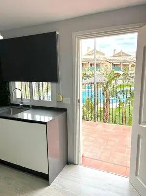 a kitchen with a large sliding glass door to a patio at Unifamiliar Chiclana, La Barrosa in Chiclana de la Frontera