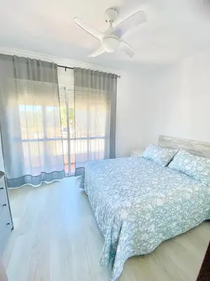 a bedroom with a bed and a ceiling fan at Unifamiliar Chiclana, La Barrosa in Chiclana de la Frontera