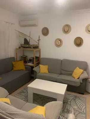 a living room with two couches and a table at Casa en la playa 750 m La Barrosa in Cádiz