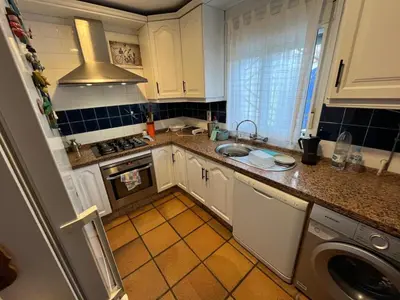 a kitchen with a sink and a dishwasher at Casa en la playa 750 m La Barrosa in Cádiz