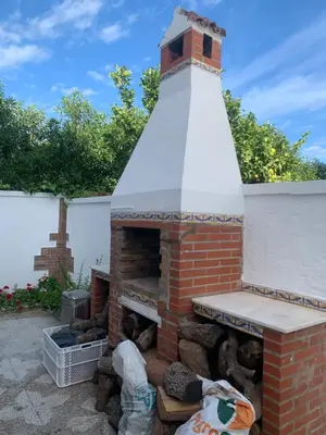 a brick fireplace with a lighthouse on top of it at Casa en la playa 750 m La Barrosa in Cádiz