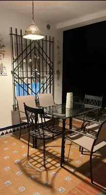 a dining room with a glass table and chairs at Casa en la playa 750 m La Barrosa in Cádiz