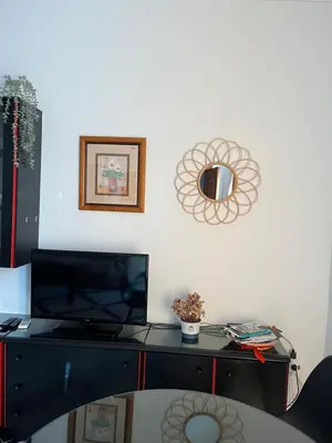 a desk with a mirror on a white wall at Apartamento LUNA in Arcos de la Frontera