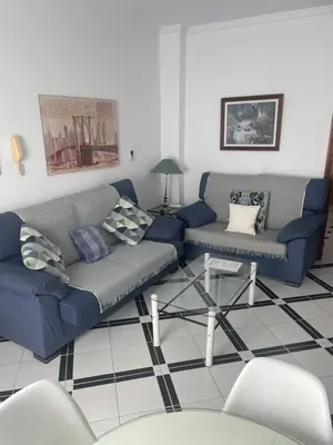 a living room with two couches and a table at Apartamento SOL in Arcos de la Frontera