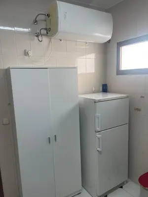 a kitchen with a white refrigerator and a sink at Apartamento SOL in Arcos de la Frontera