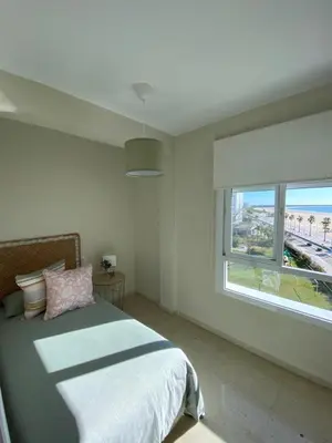 a bedroom with a bed and a large window at La ilusión de Pepa in El Puerto de Santa María