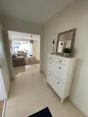 a living room with a dresser and a mirror at La ilusión de Pepa in El Puerto de Santa María