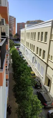 a row of cars parked on a street next to buildings at Piso en la Caleta in Cádiz