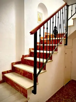 a staircase in a house with red and white stairs at MyChoice Casa Milagros in Rota