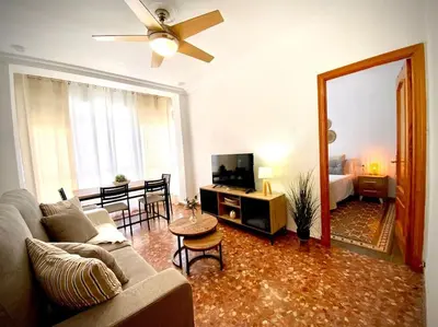a living room with a couch and a tv and a mirror at MyChoice Casa Milagros in Rota