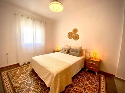 a bedroom with a large bed and a window at MyChoice Casa Milagros in Rota