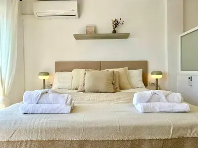 a bedroom with a large bed with two pillows on it at GATU Villa Mar 