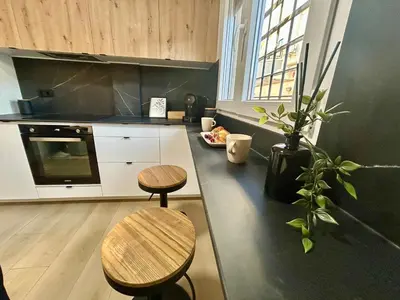 a kitchen with two tables and two stools in it at GATU Villa Mar 