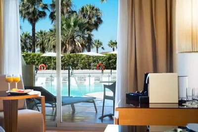 a hotel room with a view of the pool at Elba Costa Ballena Beach & Thalasso Resort in Costa Ballena